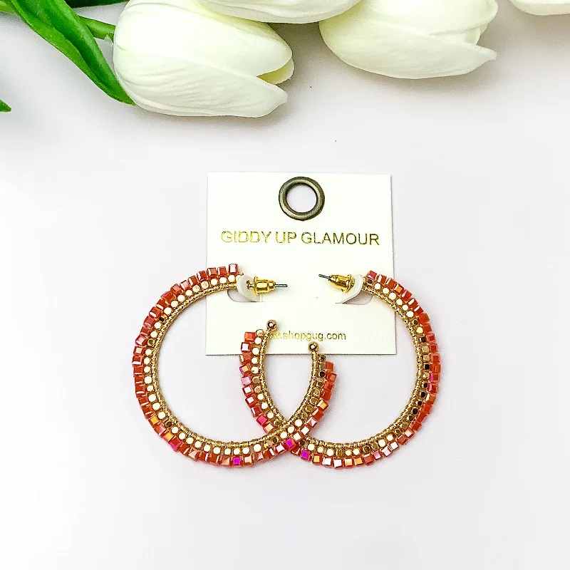 Thick tier earrings-Gold Tone Beaded Hoop Earrings with a Red Orange Crystal Outline